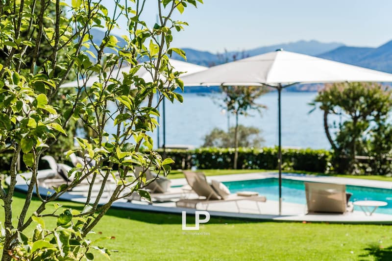 sun loungers, pool, large umbrellas, mountains, water
