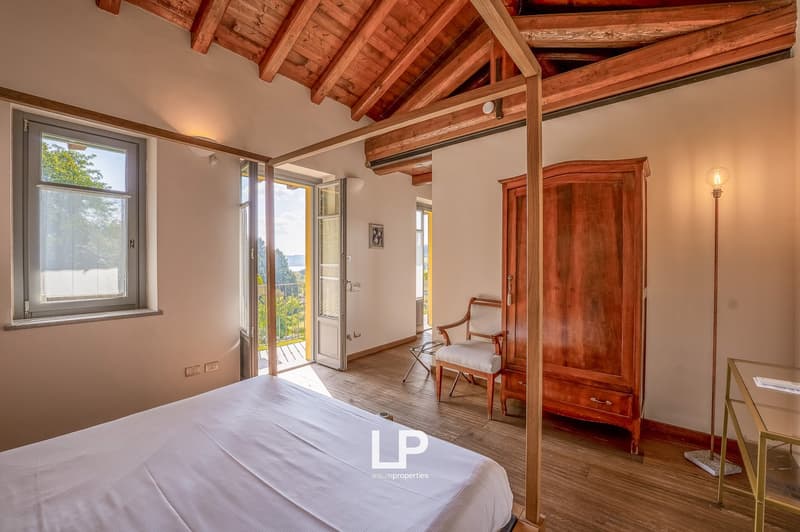 wooden ceiling, large window, bed, wooden chair, wooden cabinet, balcony, outdoor view