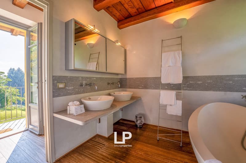 double sinks, mirror, shower, bathtub, balcony, garden view