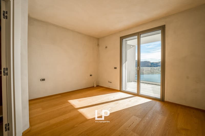 modern empty room, glass sliding doors, balcony, wooden floor, natural light, white walls