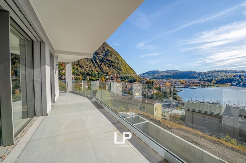 glass balcony railing, panoramic view of mountains and lake, clear sky