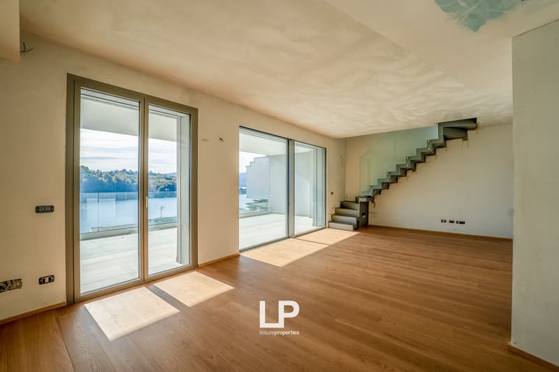large glass windows, hardwood floor, unfurnished, glass staircase, scenic view
