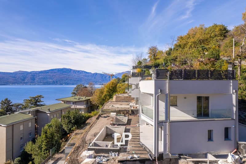 Modern apartment buildings, hillside, view of lake and mountains