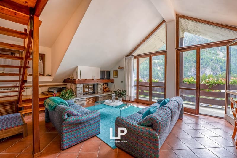 fireplace, large windows, balcony, two-seater sofas, coffee table, stairs, wooden shelves