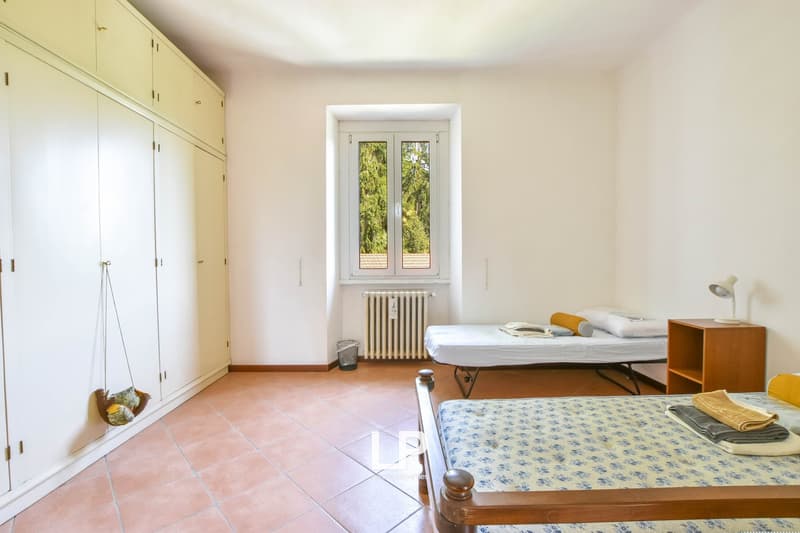 room with tiled floor, white walls, 3 beds, wardrobes, window with view, radiator