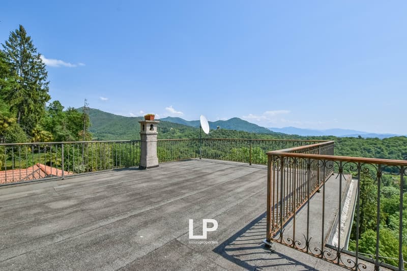 large deck with wooden railings, view of mountains, satellite dish