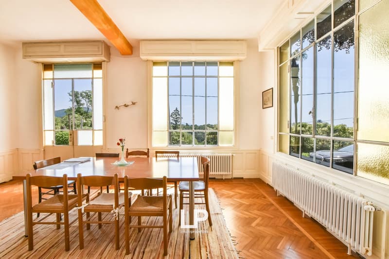 dining room, large wooden table, wooden chairs, large windows, wooden floor, radiators