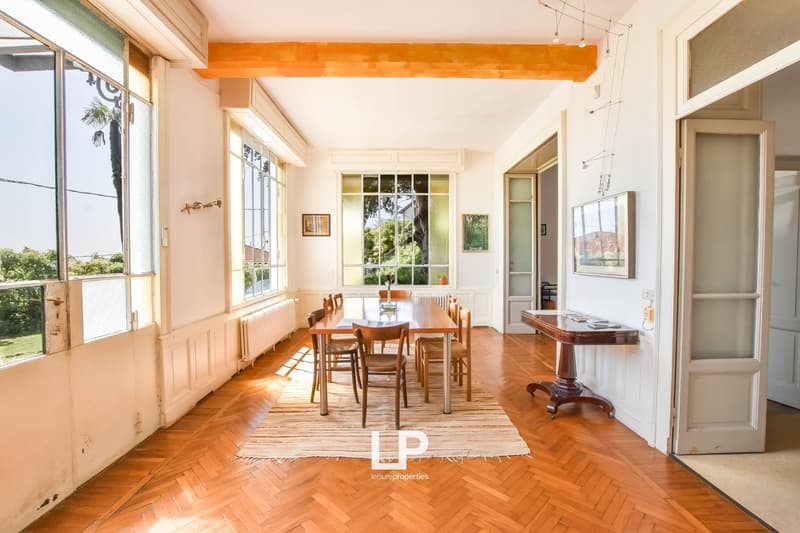 wooden floor, wooden table and chairs, radiator, glass doors, open space, view to outside