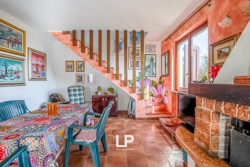 dining room, dining table, chairs, fireplace, open staircase, tile flooring