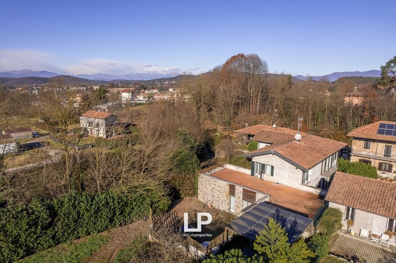 2 story house, brick, terracotta roof, solar panels, solar panels on detached building