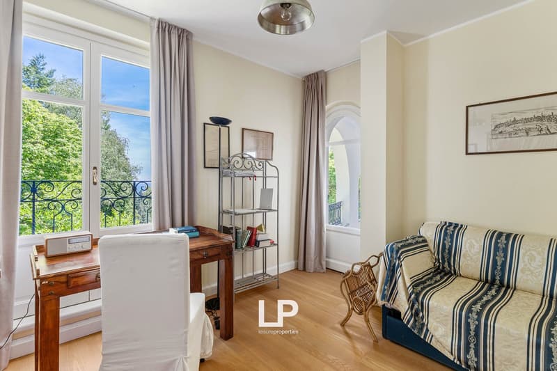 Balcony, double doors, desk, chair, shelves, radio, sofa, arch window, picture frame