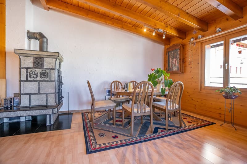 Fireplace, rug, dining table, chairs, wooden wall, picture frame
