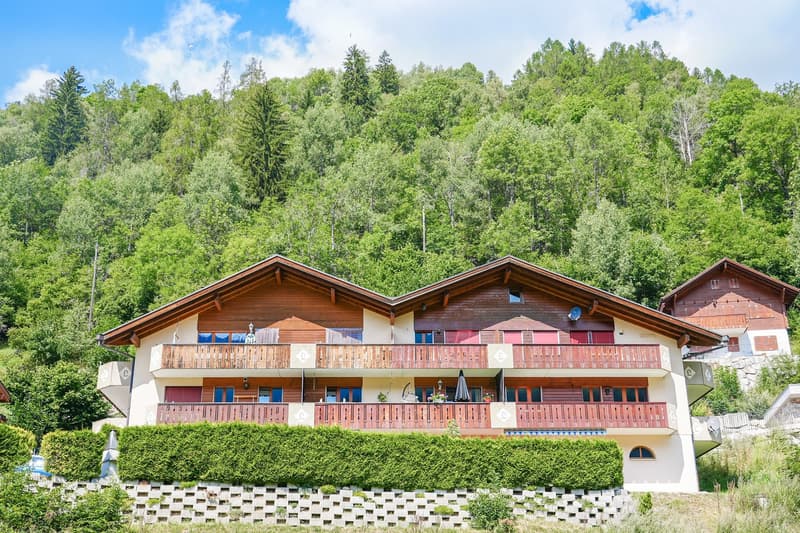 Alpine style house, three floors, balconies, red and white color