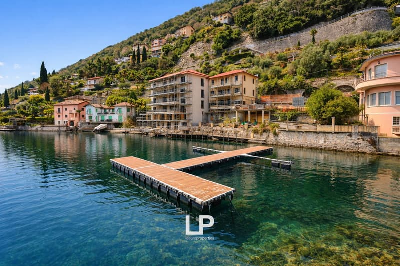 Hill with buildings on top, lake with dock