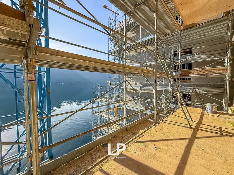 under construction balcony overlooking the lake, metal scaffolding
