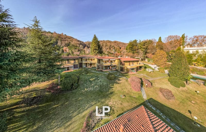 Detached houses, tiled roofs, swimming pool, wide green areas