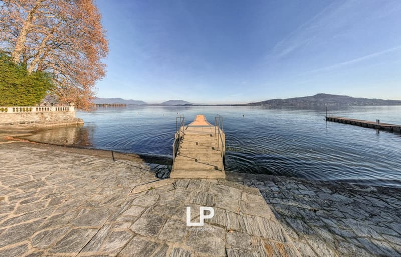 stone floor, stairs, body of water, boat dock, clear sky, mountains