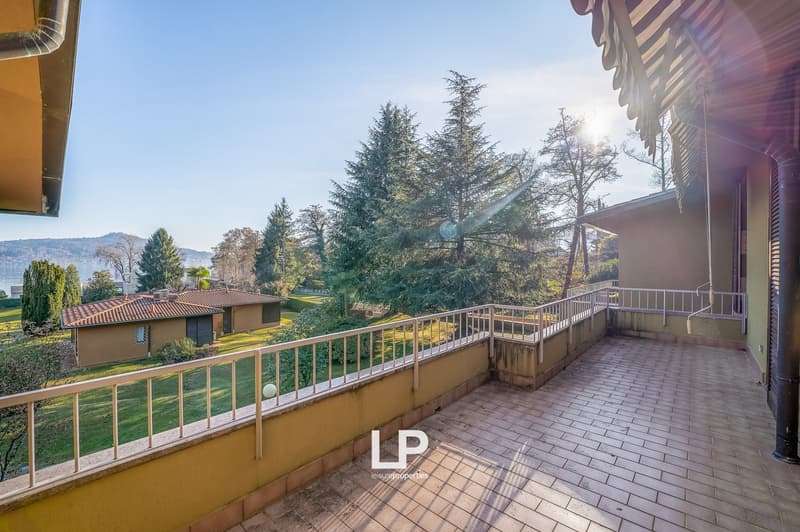 tiled terrace with railings, views of garden and lake