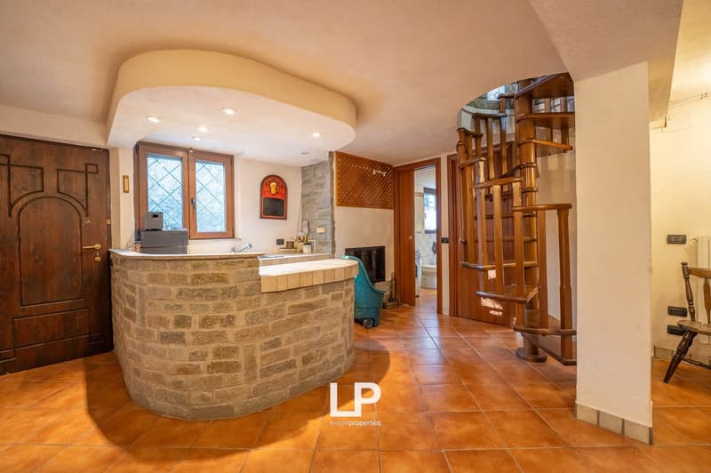 kitchen counter with appliances, fireplace, spiral staircase