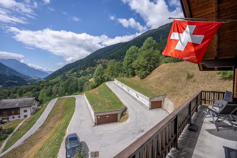 elevated position with mountain view, underground garages, driveway, balcony, Swiss flag