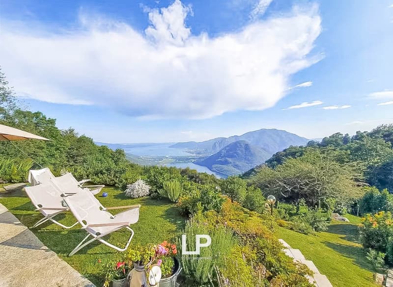 garden with a view, 2 lounge chairs, plants, flowers, umbrella, lake, mountain range, trees
