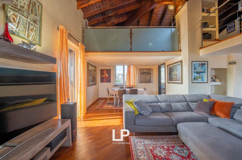 wooden floors, modern grey sofa, large screen, fireplace, balcony