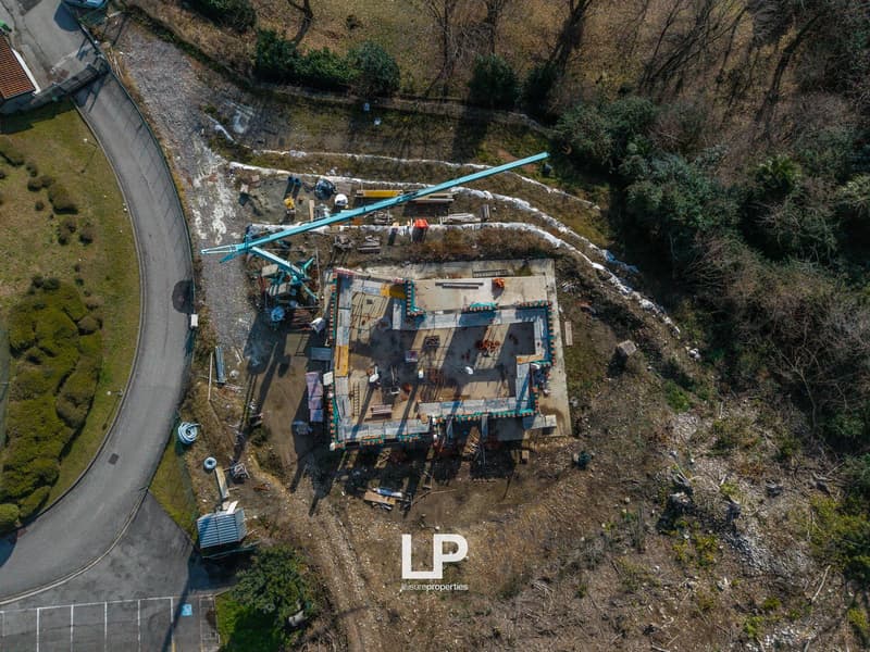 new house in construction, foundation work, large square shape, elevated foundation, construction materials around