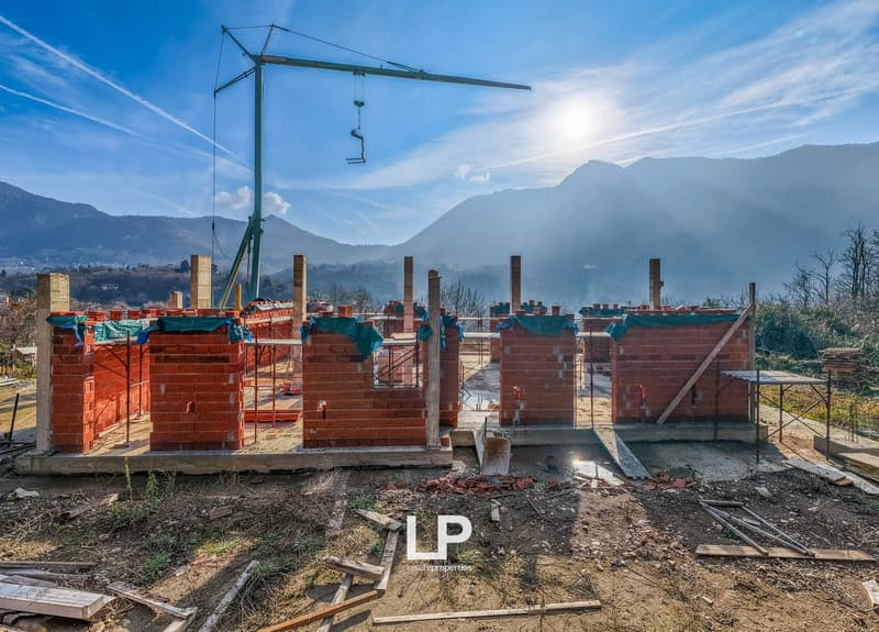 Construction site, red bricks, steel frames, construction crane, mountains in the background, unfinished structure