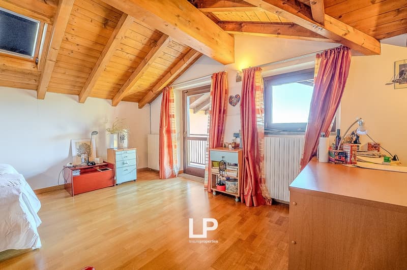 Bedroom with wooden floors, white walls, bed, windows, wardrobe, desk, curtains