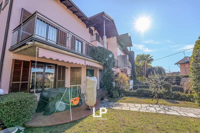 2-story pink house, balcony, wooden door, large windows, grass garden, swing