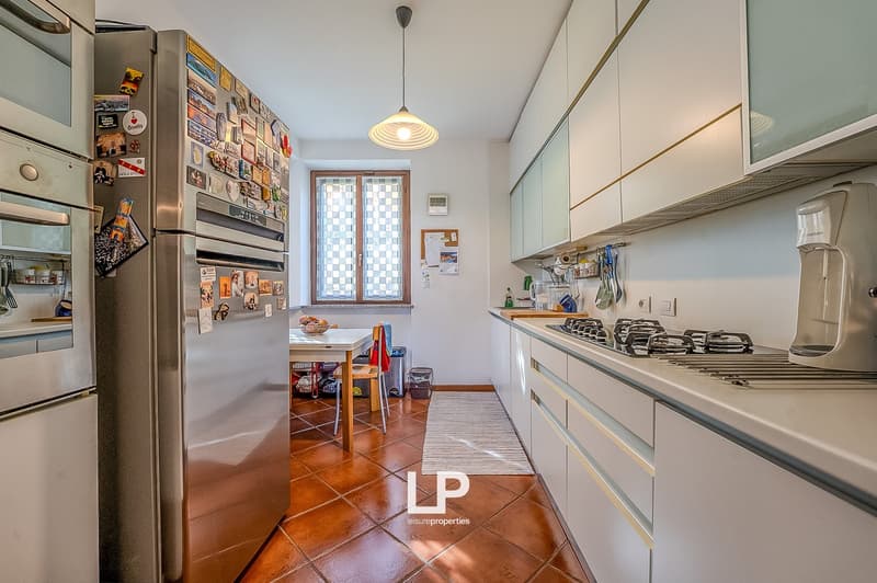 Stylish kitchen with stainless steel appliances, large kitchen island, wooden floor