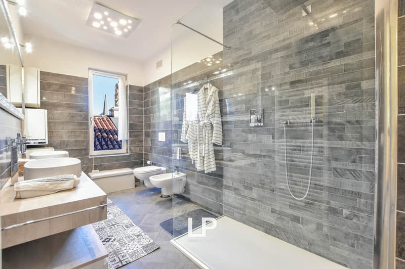 shower, sink, toilet, bidet, towel, robe, window, gray tiles, white fixtures, vanity, floor mat, modern style