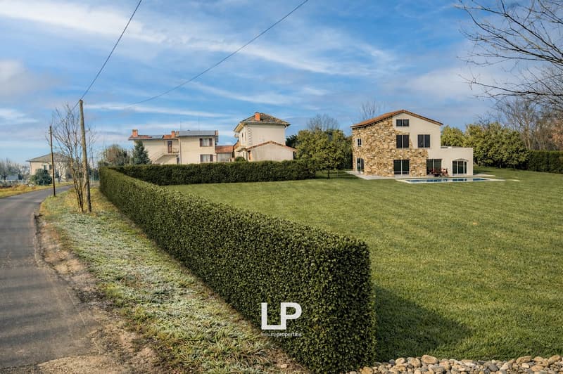 Stone house with swimming pool, large garden, hedge, two other houses in the background