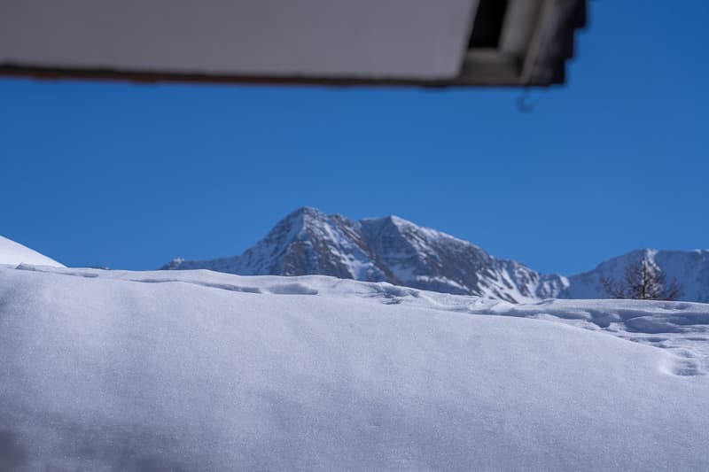 snowy landscape with mountains in the background
