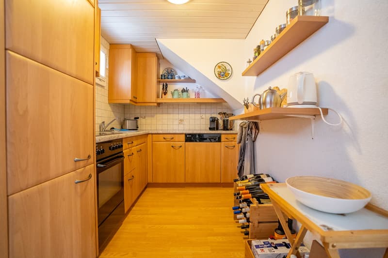 modern kitchen with wooden cabinets, tiled floor, sink, oven, dishwasher, shelves, wine rack