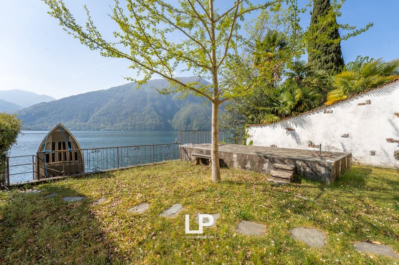 lake view, stone bench, tree, boat, metal fence, white wall