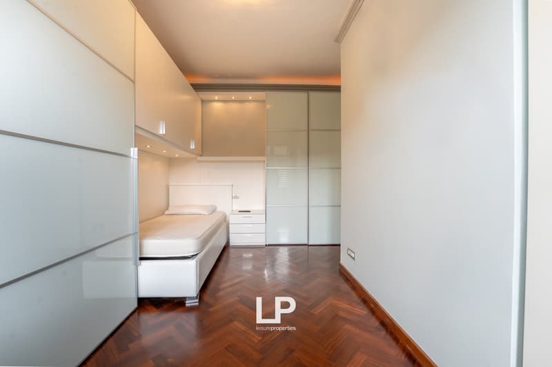 modern bedroom with wooden floor, white bed, white nightstand, white wardrobes, white walls
