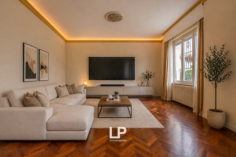modern living room with white sofa, wooden coffee table, flat screen TV, wooden floor, white walls, two paintings, radiator, window with curtains, potted plants
