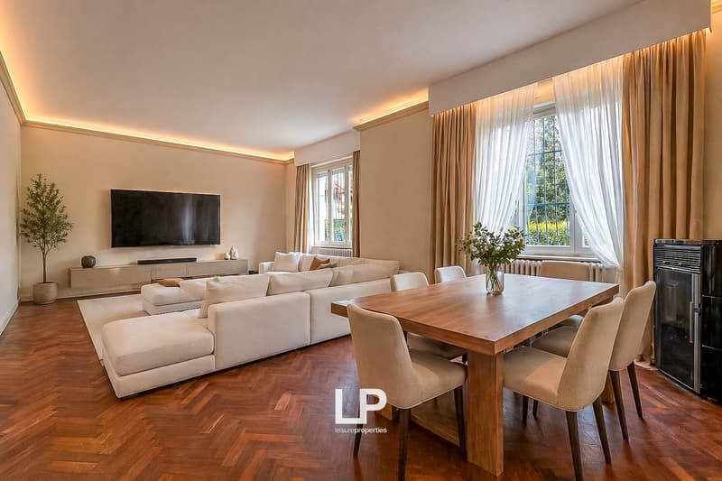 modern living room with white sofa, wooden dining table, TV, wooden floor, large windows