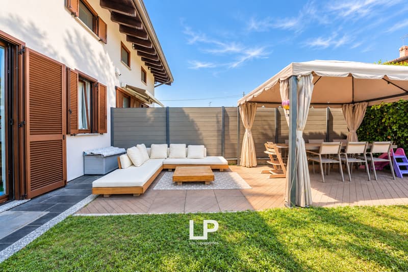 Patio moderno con pergola e giardino