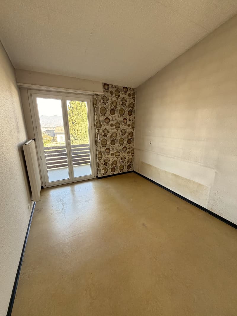 empty room, sliding glass door, balcony, wallpaper, heater, wooden floor