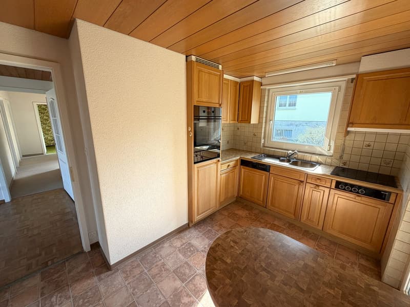 kitchen with wooden cabinets, tiled floor, sink, oven, dishwasher, window