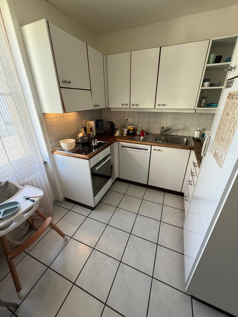 white kitchen with tiled floor, white cabinets, sink, dishwasher, gas stove, refrigerator