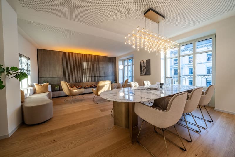 Marble table, multiple white chairs, fireplace, large window