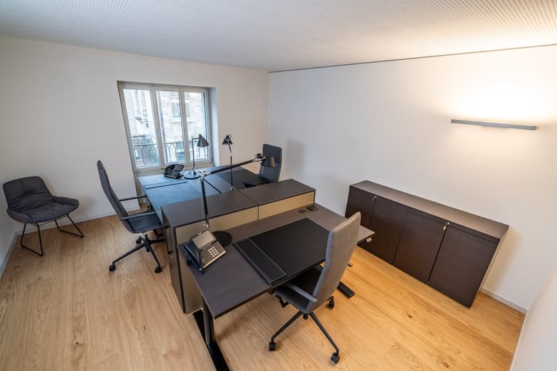 modern office with desk, lamps, chairs, cabinet, window
