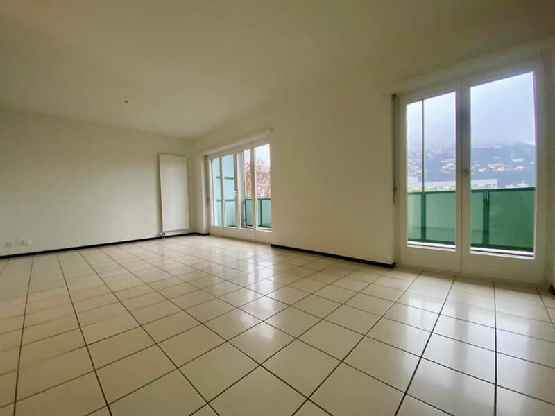 empty room, white tiled floor, sliding glass doors, balcony, mountain view