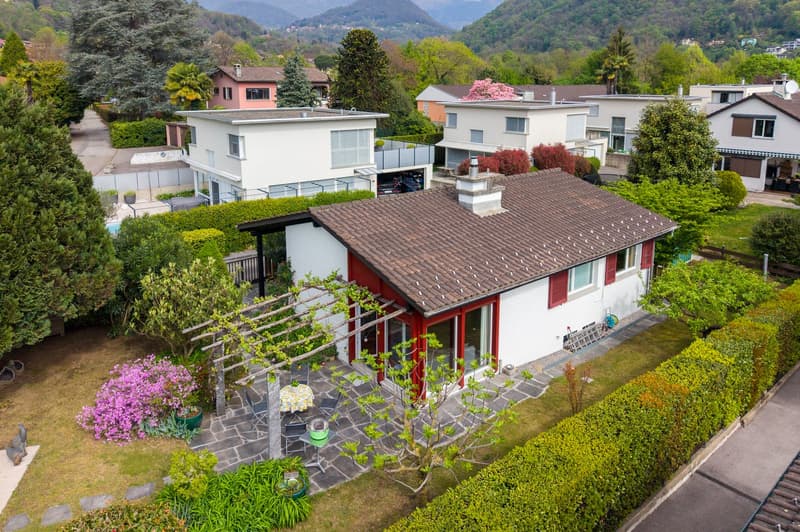 Detached house, brown roof, red trim, garage, garden, mountain view