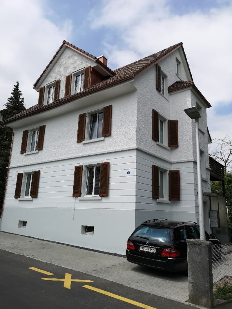 2 story white house, brown shutters, brown roof, car parked in front