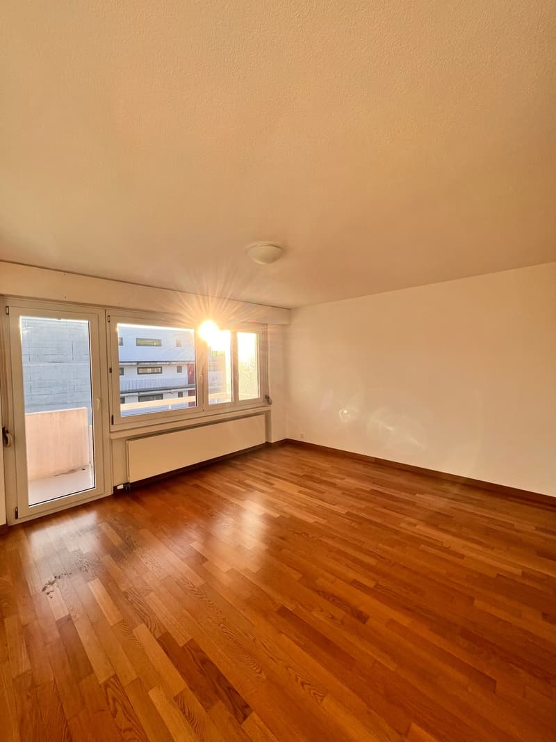 empty room, wooden floor, white walls, large windows, balcony, sunlight