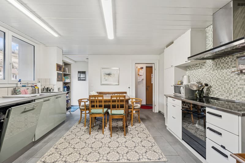 Kochen mit Stil im EG - grosszügige Küche mit Tiba-Kombi-Herd, Vorratsraum und Zugang zum teils gedeckten Balkon